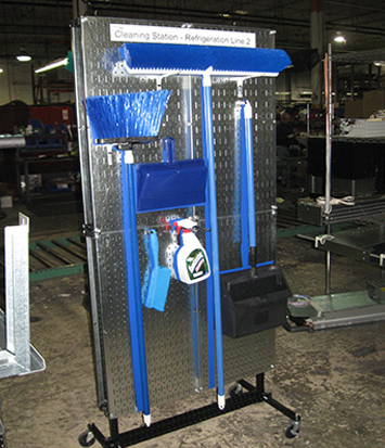 Blue brooms and cleaning supplies on a Mobile Cleaning Station made Flex Craft steel tubing.