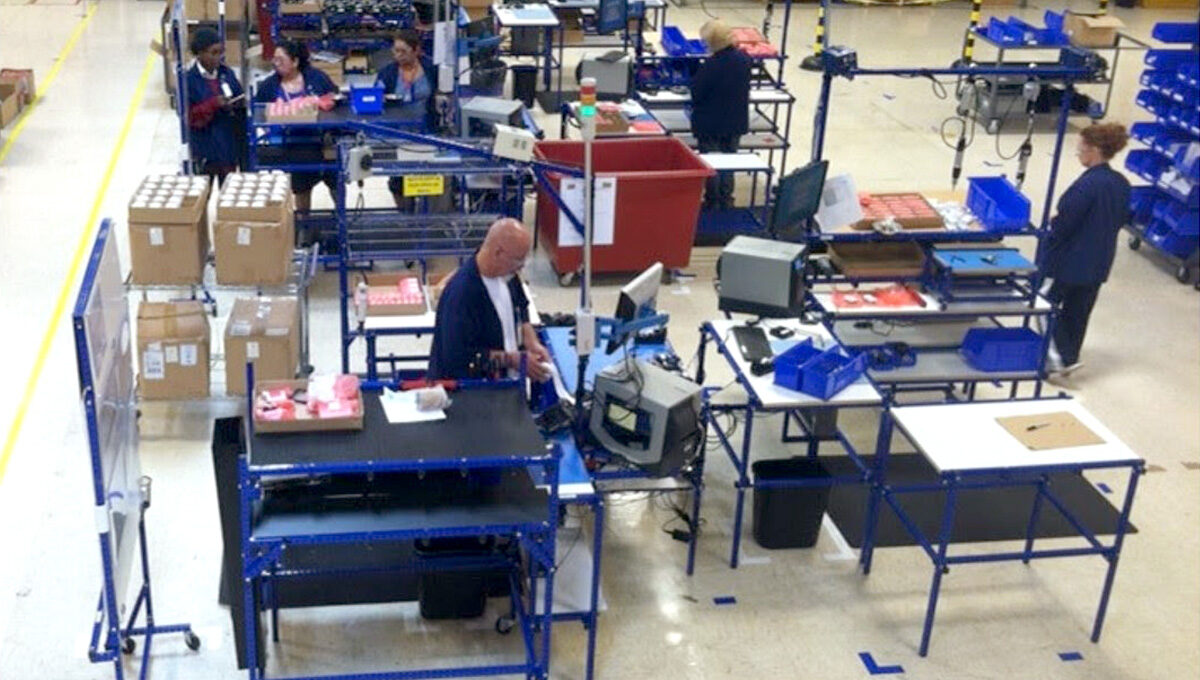 Employees in work-cells at workstations made from Flex Craft tubing.