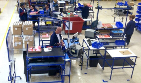 Employees in work-cells at workstations made from Flex Craft tubing.