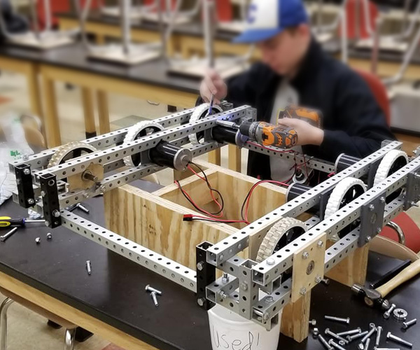 A local high school robotics team member working on their robot using Flex Craft products.